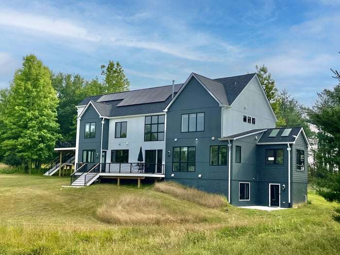 Custom LEED Gold-Certified Smart Home back exterior featuring deck and stairs to backyard