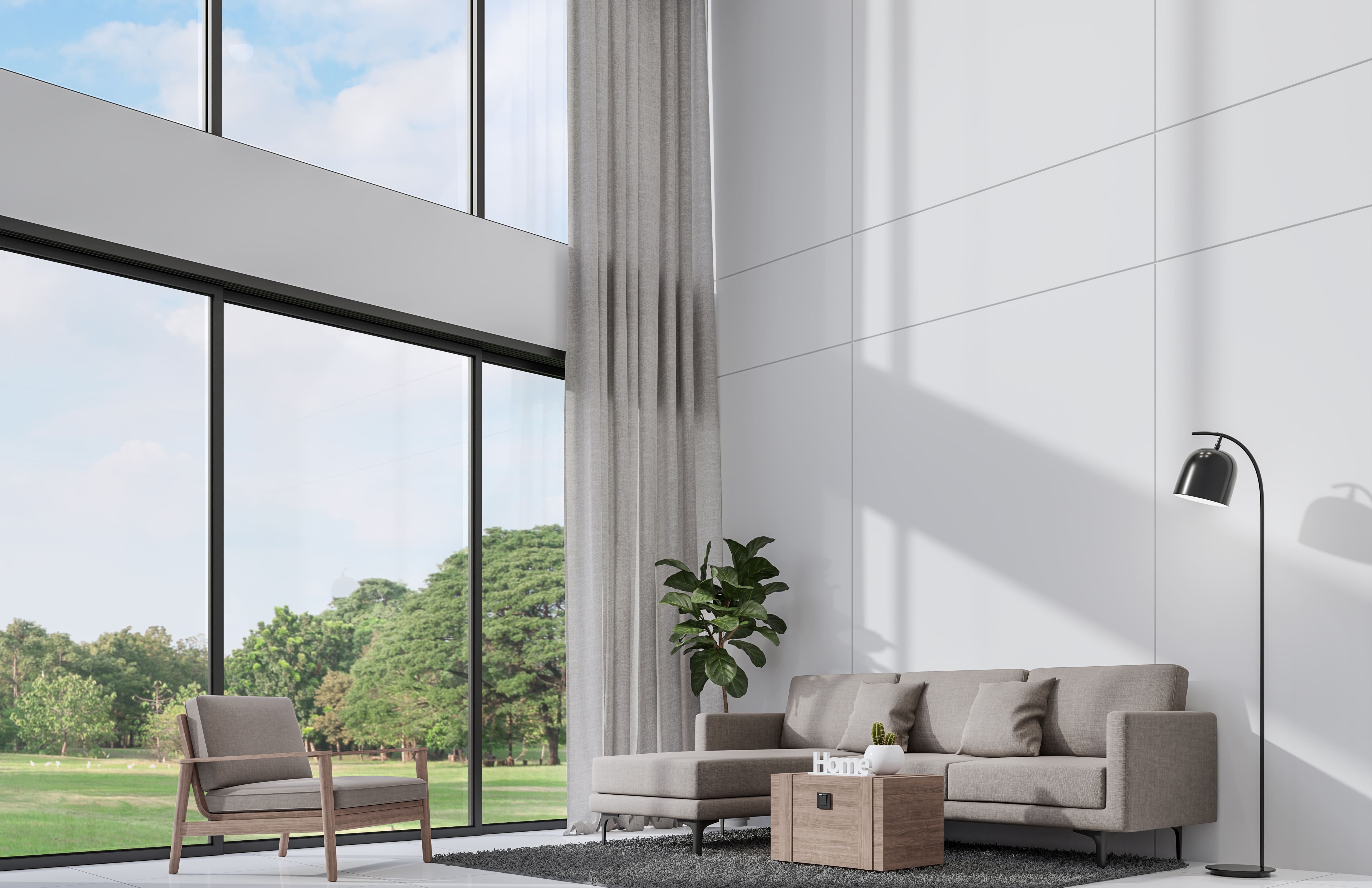 Contemporary living room design with heigh ceilings and large panoramic style windows inside a DC Metro custom home