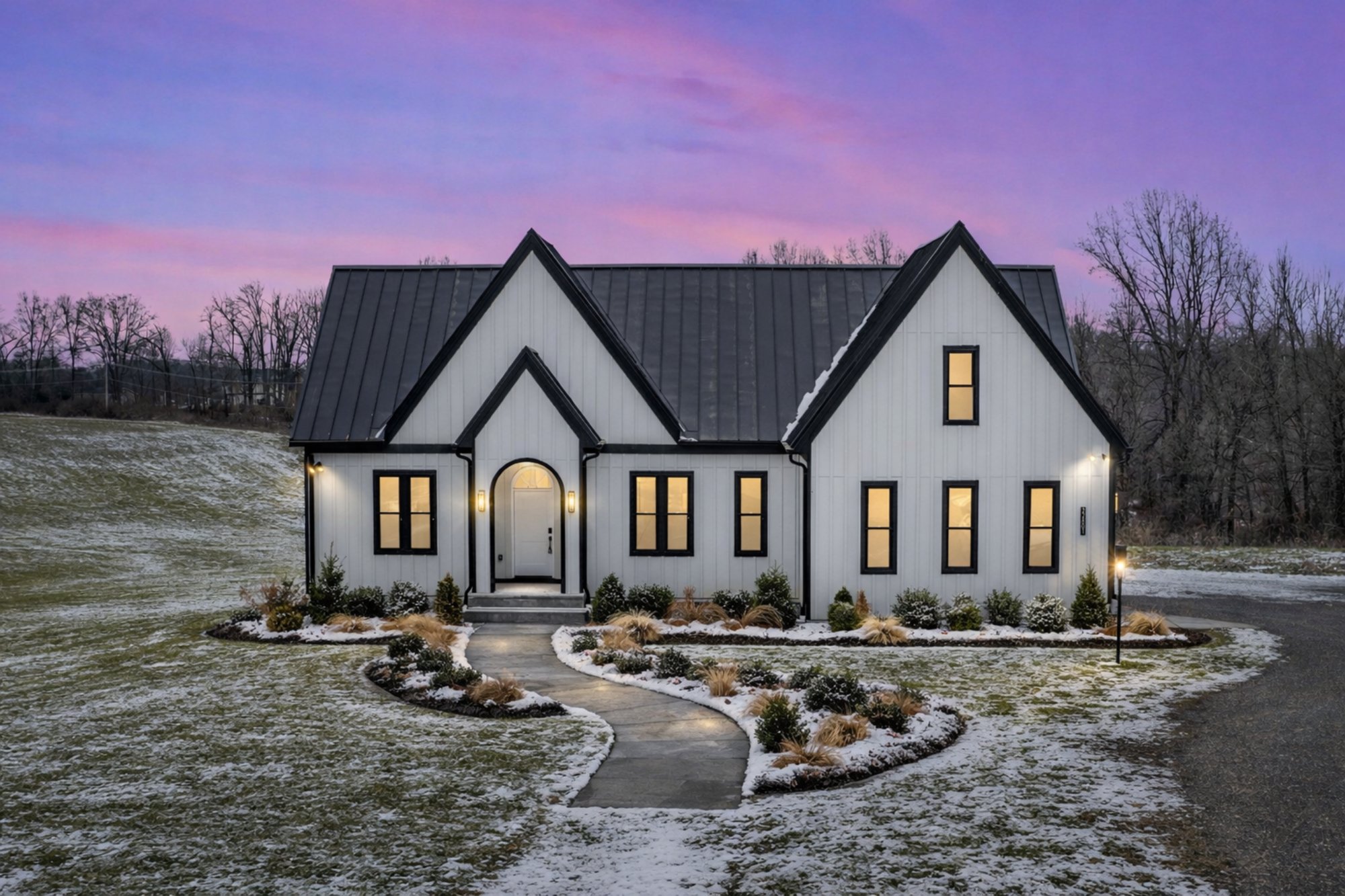 montgomery co multigenerational exterior by august homes modern farmhouse with black roof winter landscape and curved walkway