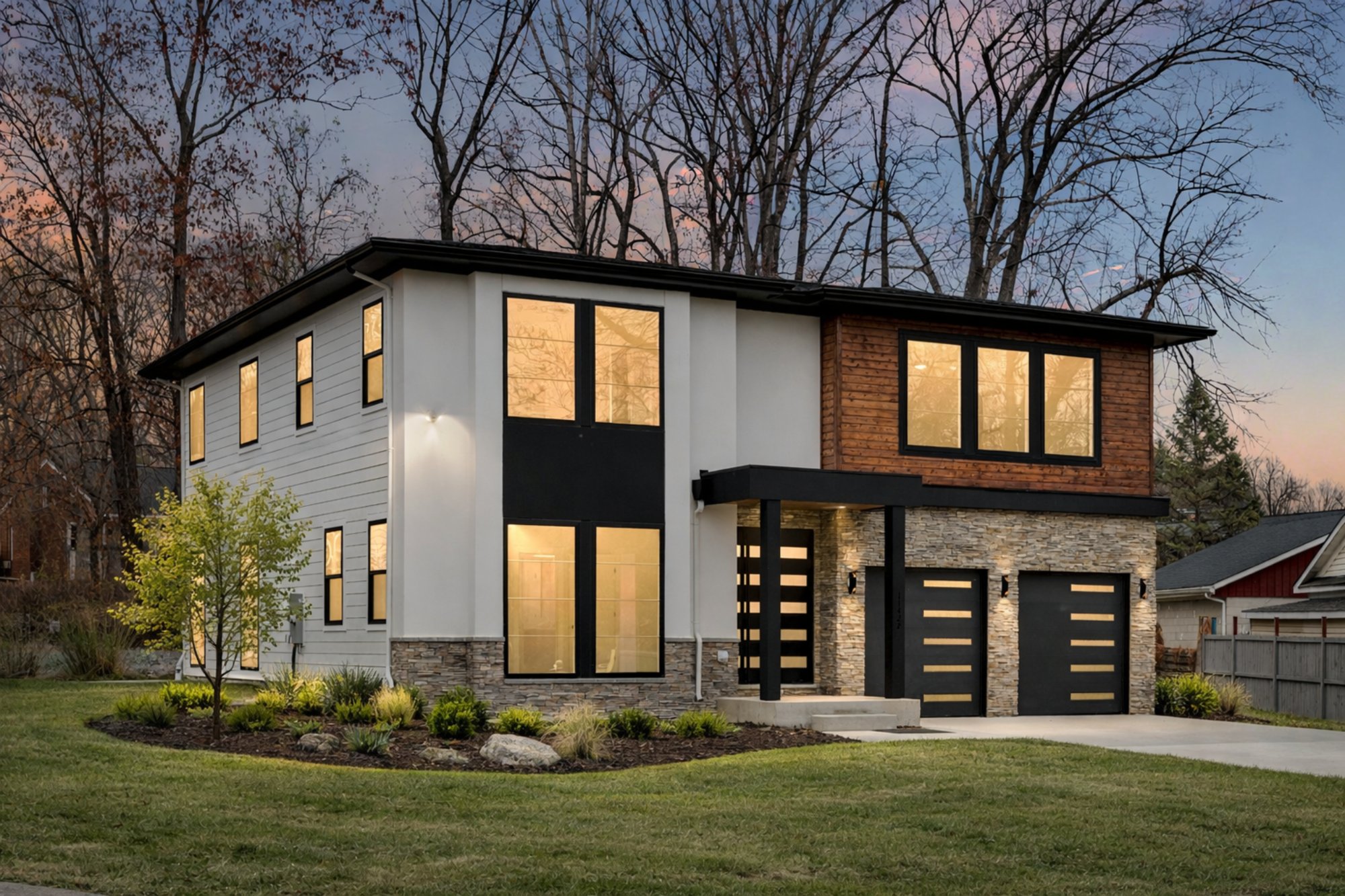 the langston exterior by august homes modern two story home with mixed materials large windows and landscaped yard at dusk